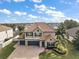 Two-story home with tile roof and landscaped yard at 17889 Gourd Neck Loop, Winter Garden, FL 34787