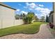 Landscaped backyard with a brick-paved walkway at 17889 Gourd Neck Loop, Winter Garden, FL 34787