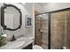 Bathroom with granite vanity, tiled shower, and decorative mirror at 17889 Gourd Neck Loop, Winter Garden, FL 34787