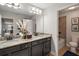 Double vanity bathroom with granite countertop and shower/tub combo at 17889 Gourd Neck Loop, Winter Garden, FL 34787