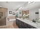 Double vanity bathroom with granite countertop and soaking tub at 17889 Gourd Neck Loop, Winter Garden, FL 34787