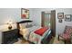 Cozy bedroom with a queen-size bed, dark wood furniture, and red blanket at 17889 Gourd Neck Loop, Winter Garden, FL 34787