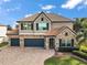 Two-story house with a stone and stucco exterior, tile roof, and a 3-car garage at 17889 Gourd Neck Loop, Winter Garden, FL 34787