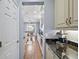 View down kitchen hallway with granite countertops and coffee bar at 17889 Gourd Neck Loop, Winter Garden, FL 34787