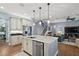 Island kitchen with stainless steel appliances and white cabinets at 17889 Gourd Neck Loop, Winter Garden, FL 34787