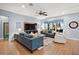 Spacious living room with teal sofas, large TV, and hardwood floors at 17889 Gourd Neck Loop, Winter Garden, FL 34787