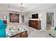 Elegant main bedroom with king bed, large dresser, and ensuite bath at 17889 Gourd Neck Loop, Winter Garden, FL 34787