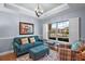 Cozy sitting area with teal sofa and large window at 17889 Gourd Neck Loop, Winter Garden, FL 34787