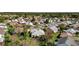 Aerial view of a house nestled in a community with mature trees and green lawns at 1916 Antonia Pl, The Villages, FL 32159