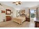 Large bedroom with wood furniture and large windows at 1916 Antonia Pl, The Villages, FL 32159