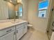 Bathroom with a single vanity, quartz countertop, and a glass-enclosed shower at 2022 Wallingford Loop, Mount Dora, FL 32757