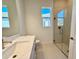 Modern bathroom with single vanity, quartz countertop and a shower at 2022 Wallingford Loop, Mount Dora, FL 32757