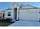 Curb appeal! One story home with light gray siding, stone accents and a two-car garage at 2022 Wallingford Loop, Mount Dora, FL 32757