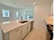 Modern kitchen with island, white cabinets and stainless steel appliances at 2022 Wallingford Loop, Mount Dora, FL 32757