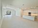 Open concept kitchen with island, white cabinets, and a breakfast bar at 2022 Wallingford Loop, Mount Dora, FL 32757