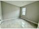 Well-lit bedroom featuring neutral walls and tile flooring at 2046 Wallingford Loop, Mount Dora, FL 32757