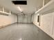 Spacious garage with epoxy flooring and overhead storage shelves at 2046 Wallingford Loop, Mount Dora, FL 32757