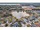 Aerial view of a house community with lake at 2054 Vision Ct, The Villages, FL 32163