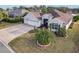 Three-car garage home with curb appeal and a spacious front yard at 2054 Vision Ct, The Villages, FL 32163