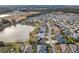 Aerial view showing a neighborhood with houses near a lake at 2054 Vision Ct, The Villages, FL 32163