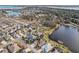 Aerial view of a residential neighborhood with houses, lakes, and lush greenery at 2054 Vision Ct, The Villages, FL 32163