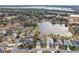 Aerial view of a lakefront community with houses and lush landscaping at 2054 Vision Ct, The Villages, FL 32163