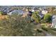 Backyard view showing a house with lush landscaping and palm trees at 2054 Vision Ct, The Villages, FL 32163