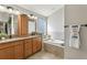 Double vanity bathroom with a soaking tub at 2054 Vision Ct, The Villages, FL 32163