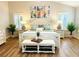 Bright bedroom with a king-size bed, white nightstands, and decorative artwork at 2054 Vision Ct, The Villages, FL 32163