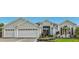 Three-car garage, mature landscaping, inviting front entrance at 2054 Vision Ct, The Villages, FL 32163