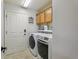 Laundry room with washer, dryer and cabinets at 2054 Vision Ct, The Villages, FL 32163