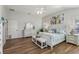 Main bedroom with white furniture and wood floors at 2054 Vision Ct, The Villages, FL 32163