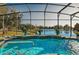 Relaxing pool and spa with lake view and screened enclosure at 2054 Vision Ct, The Villages, FL 32163