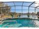 Screened pool and spa overlooking a peaceful lake at 2054 Vision Ct, The Villages, FL 32163