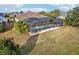 Enclosed pool area with patio furniture and lush landscaping at 2054 Vision Ct, The Villages, FL 32163