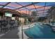 Inviting pool area with a tiki bar and hot tub at 2054 Vision Ct, The Villages, FL 32163