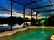 Relaxing screened pool overlooking lake at sunset at 2054 Vision Ct, The Villages, FL 32163