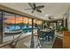 Spacious sunroom with pool and lake views, dining furniture at 2054 Vision Ct, The Villages, FL 32163