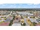 Aerial view showing neighborhood homes, landscaping, and a lake at 2080 Nordic Ln, The Villages, FL 32163