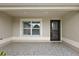 Covered entryway with a window and a decorative door at 2080 Nordic Ln, The Villages, FL 32163