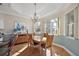 Bright dining room with hardwood floors and a view of the golf course at 2202 Blackville Dr, The Villages, FL 32162