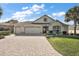 Beautiful home with a three-car garage and landscaped yard at 2202 Blackville Dr, The Villages, FL 32162