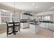 Kitchen with breakfast nook, white cabinets and granite countertops at 2202 Blackville Dr, The Villages, FL 32162