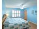 Light blue bedroom with wood floors and a king-size bed at 2219 Welcome Way, The Villages, FL 32162