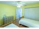 Bright bedroom with two twin beds, dresser, and ceiling fan at 2219 Welcome Way, The Villages, FL 32162