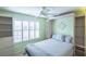 Guest bedroom with built-in shelves and a comfortable bed at 2219 Welcome Way, The Villages, FL 32162