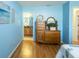 Bedroom with wood dresser and view of bathroom at 2219 Welcome Way, The Villages, FL 32162