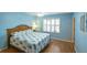 Bedroom with light blue walls and wood floors at 2219 Welcome Way, The Villages, FL 32162