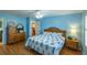 Light and airy bedroom with wood furniture and pineapple bedding at 2219 Welcome Way, The Villages, FL 32162