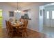 Dining room with wood table and chairs, open to kitchen at 2219 Welcome Way, The Villages, FL 32162